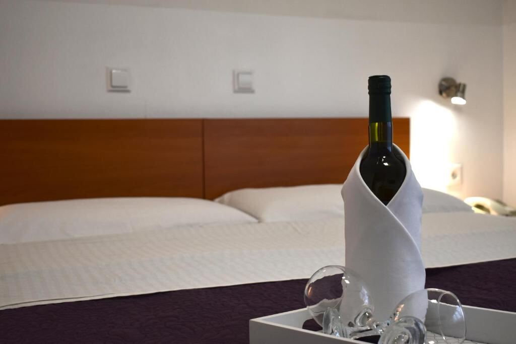 Hotel Fala Zagreb - guest room with beds and a welcome bottle of wine
